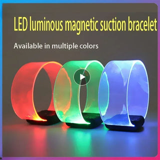 Colorful LED luminous magnetic suction bracelets in red, green, and blue on a dark background