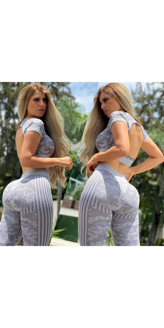 Two women wearing gray seamless sports suits posing outdoors in a natural setting