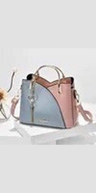 Fashionable patchwork tote bag with block handle and stitching details, in a stylish combination of blue and pink colors, perfect for carrying essentials.