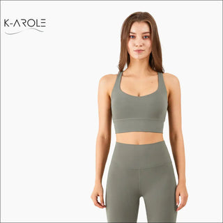 Sleek, trendy women's sports bra from K-AROLE featured in the image. The grey, cross-back design offers a stylish and supportive look for active lifestyles.