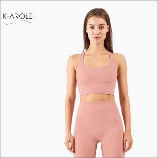 Stylish pink sports bra and leggings set from K-AROLE, featuring a cross-back design for a comfortable, supportive fit during yoga and other activities.