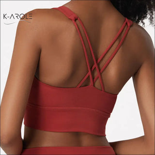 Stylish red sports bra with criss-cross back straps from K-AROLE women's activewear collection.