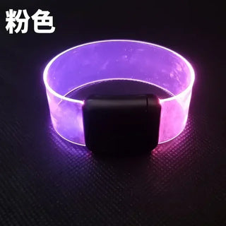 Vibrant LED light-up bracelet in purple, featuring a sleek black module for sound-activated flashing and illumination, perfect for party or safety use.