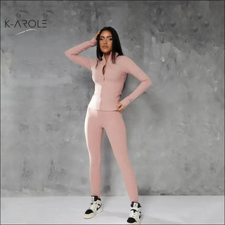 Fitted pink legging and jacket set, K-AROLE™️ branded, model wearing matching activewear pieces posing against grey background