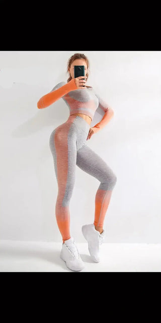 Stylish women's two-tone athletic leggings with phone in hand, showing modern workout wear with a sleek, form-fitting design.