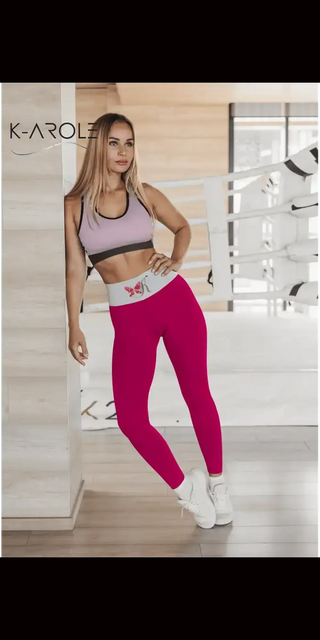 Stylish athleisure outfit: deep fuchsia K-AROLE™️ comfort yoga leggings with a pink sports bra, showcased on a fit female model against a branded backdrop
