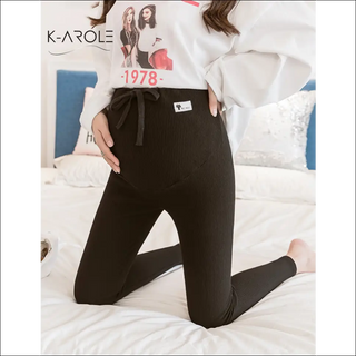 Stylish black maternity leggings from K-AROLE, featuring a comfortable and flattering design for expectant mothers.