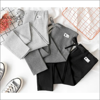 Stylish K-AROLE™️ maternity leggings in gray and black, displayed on a white background with floral accents and sneakers, showcasing trendy spring/summer outfits.