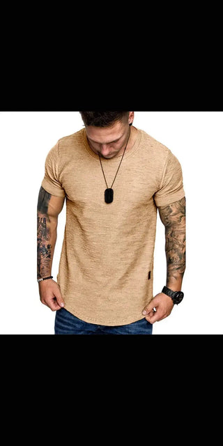 Casual beige tee with tattoo-adorned man in focused pose