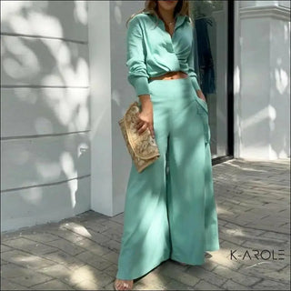 Woman in mint green casual clothing standing near glass door