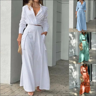 Elegant white wrap maxi dress with pockets featured in a fashionable outfit from the K-AROLE clothing line. The dress showcases a sophisticated and stylish look.