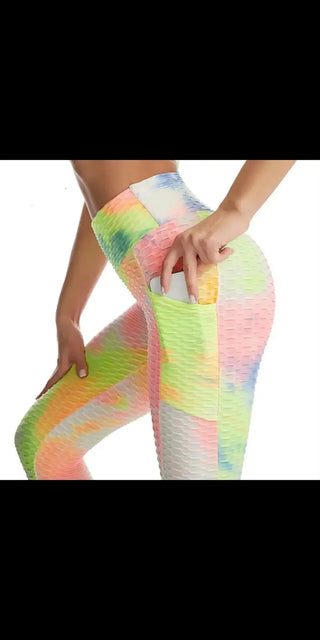 Stylish tie-dye yoga leggings from K-AROLE. Vibrant, colorful design with a high-waisted fit for a flattering look. Flexible and comfortable sportswear for fitness.