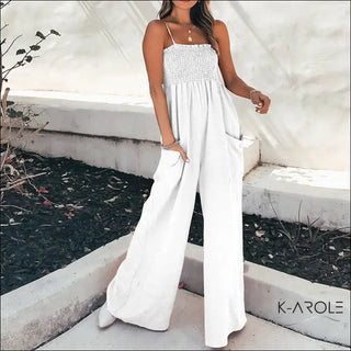 Elegant white jumpsuit from K-AROLE, featuring a smocked bodice and wide-leg silhouette, creating a stylish and comfortable look.