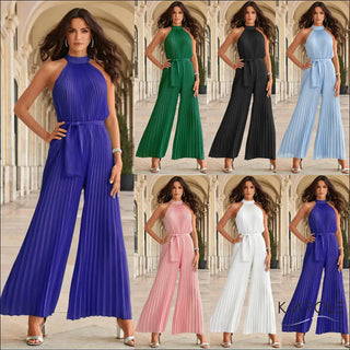 Stylish women's jumpsuits in various vibrant colors including purple, green, black, blue, pink, and white displayed against an ornate architectural background. The jumpsuits feature sleeveless halter-style tops, wide leg pants, and pleated or belted waists, showcasing fashionable and versatile casual attire.