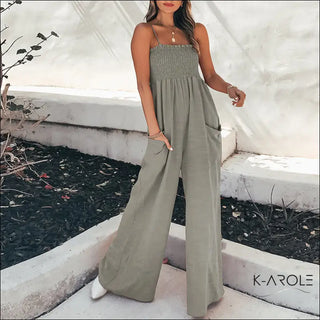 Casual women's sleeveless gray jumpsuit with a smocked bodice, featured in the image from K-AROLE's fashion collection.