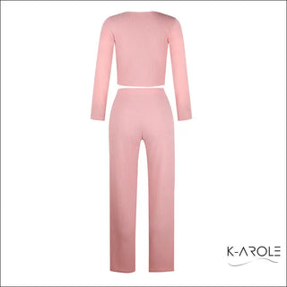 Stylish women's long sleeve set in soft, blush-toned ribbed fabric. The close-fitting top and wide-leg pants create a coordinated, contemporary look.