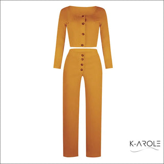 Vibrant women's two-piece set featuring a long-sleeve crop top and high-waisted trousers in a bold mustard color. The garments are adorned with decorative buttons, creating a stylish and contemporary look.