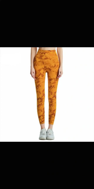 Trendy marble-patterned athletic leggings from K-AROLE featuring a vibrant orange design and comfortable, stretch fabric.