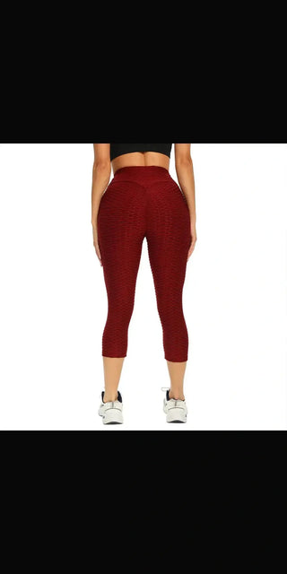 Breathable and sweat-wicking yoga pants in a stylish burgundy color.